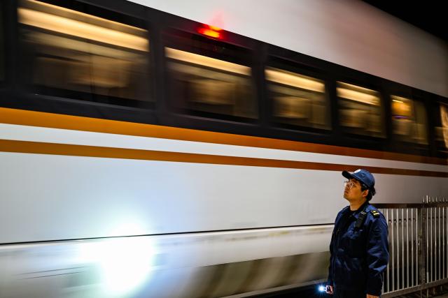 (260204) -- TIANJIN, Feb. 4, 2026 (Xinhua) -- Li Qiwei works at an electric multiple unit (EMU) maintenance depot in north China's Tianjin Municipality, on Feb. 2, 2026. Several EMU trains are neatly lined up for "health checkups" inside a maintenance depot in Tianjin at the night of Feb. 1, right before the start of Spring Festival travel rush, the annual homeward journey in China, and also the world's largest human migration. 
   To ensure safe and punctual departure of these trains, Li Qiwei, the leader of a maintenance team, had to work overnight with more than 40 mates on his team to perform full-body examination for 28 sets of EMUs - a workload about 20 percent higher than that of a normal workday.
   Li has been working at the maintenance depot after he graduated with a degree in vehicle engineering from the Dalian Jiaotong University. Eight years of diligence saw him rising from green hands to a competent group leader. He said he felt very lucky to be able to contribute to the safety operation of the bullet trains, which are reuniting million of people with their families during the Spring Festival travel rush. (Xinhua/Zhao Zishuo)