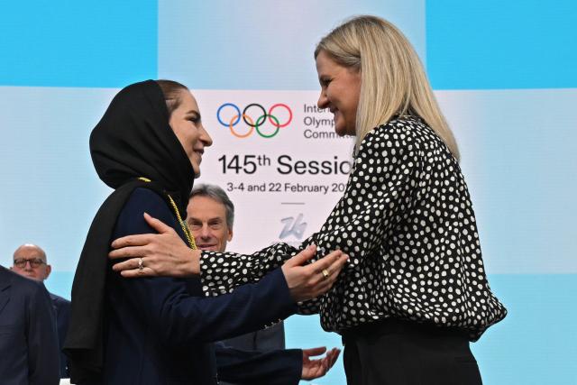 (260204) -- MILAN, Feb. 4, 2026 (Xinhua) -- Iranian badminton player Soraya Aghaei Hajiagha (L) is greeted by International Olympic Committee (IOC) President Kirsty Coventry during her oath ceremony as the newly appointed member of IOC at the 145th IOC session ahead of the 2026 Milan-Cortina Winter Olympic Games, in Milan, Italy, Feb. 4, 2026. (Daniel Munoz/POOL xia Xinhua)