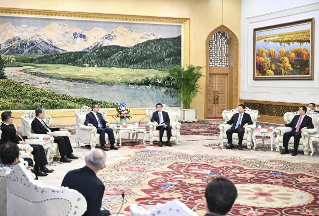 (260204) -- BEIJING, Feb. 4, 2026 (Xinhua) -- Wang Huning, a member of the Standing Committee of the Political Bureau of the Communist Party of China (CPC) Central Committee and chairman of the National Committee of the Chinese People's Political Consultative Conference, meets with the Taiwan delegation attending the think tank forum co-hosted by research institutes affiliated with the CPC and the Chinese Kuomintang (KMT) party in Beijing, capital of China, Feb. 4, 2026. The Taiwan delegation was led by Hsiao Hsu-tsen, vice chairman of the KMT. (Xinhua/Li Xiang)