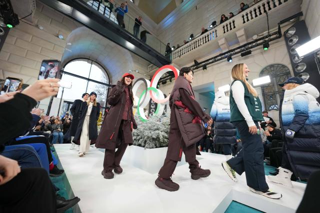 (260204) -- MILAN, Feb. 4, 2026 (Xinhua) -- Athletes and models present outfits during a fashion show in Milan, Italy, on Feb. 4, 2026. The International Olympic Committee (IOC) hosted an Olympic Winter Games Fashion Showcase in Milan on Wednesday. The event featured a snapshot from National Olympic Committees (NOCs), including performance wear and opening ceremony outfits, with Olympians taking to the runway. (Xue Yuge/Pool via Xinhua)