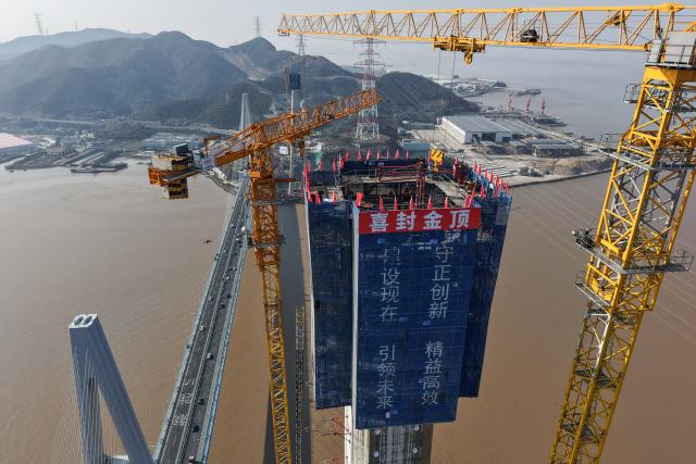 (260204) -- ZHOUSHAN, Feb. 4, 2026 (Xinhua) -- An aerial drone photo taken on Feb. 4, 2026 shows the No. 6 main tower of the Taoyaomen highway-railway bridge under construction in Zhoushan, east China's Zhejiang Province. The No. 6 main tower of the Taoyaomen highway-railway bridge, constructed by the China Railway Major Bridge Engineering Group Co., Ltd., was topped out on Wednesday, marking a significant breakthrough of this project. (Xinhua/Huang Zongzhi)
