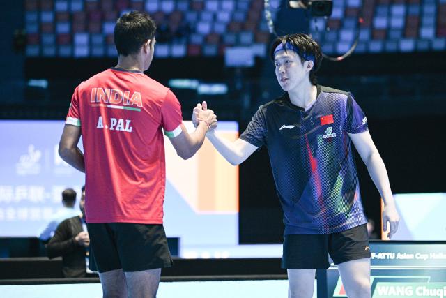 (260204) -- HAIKOU, Feb. 4, 2026 (Xinhua) -- Wang Chuqin (R) greets Akash Pal before the men's singles group match between Wang Chuqin of China and Akash Pal of India at the ITTF-ATTU Asian Cup Haikou 2026 table tennis tournament in Haikou, south China's Hainan Province, Feb. 4, 2026. (Xinhua/Pu Xiaoxu)