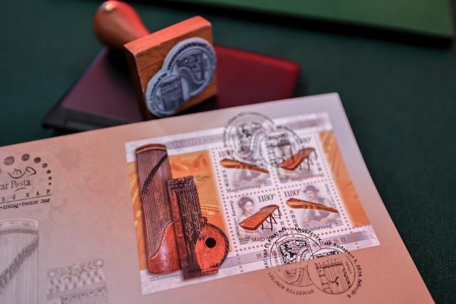 (260204) -- BUDAPEST, Feb. 4, 2026 (Xinhua) -- This photo taken on Feb. 4, 2026 shows a sheet of the "National Treasures: Traditional Hungarian and Chinese Instruments" stamps at a launch ceremony in Budapest, Hungary. Hungary and China on Wednesday jointly issued a commemorative stamp series titled "National Treasures: Traditional Hungarian and Chinese Instruments" for the upcoming Chinese New Year. (Photo by David Balogh/Xinhua)