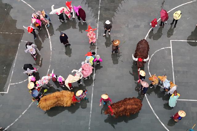 (260204) -- BEIJING, Feb. 4, 2026 (Xinhua) -- An aerial drone photo taken on Feb. 4, 2026 shows villagers taking part in an event on the occasion of "Lichun" in Guilin of south China's Guangxi Zhuang Autonomous Region. Wednesday marks "Lichun," or the Beginning of Spring, the first of the 24 solar terms on the Chinese lunar calendar. (Photo by Pan Zhixiang/Xinhua)