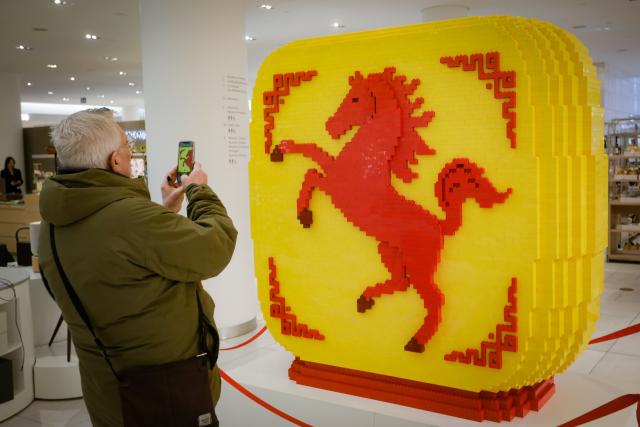(260204) -- VANCOUVER, Feb. 4, 2026 (Xinhua) -- A man takes photos of a Year of the Horse LEGO brick installation at a department store in Vancouver, British Columbia, Canada, Feb. 4, 2026. (Photo by Liang Sen/Xinhua)