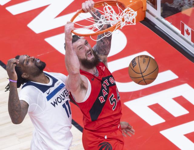 (260205) -- TORONTO, Feb. 5, 2026 (Xinhua) -- Sandro Mamukelashvili (R) of Toronto Raptors dunks during the 2025-2026 NBA regular season game between Toronto Raptors and Minnesota Timberwolves in Toronto, Canada, on Feb. 4, 2026. (Photo by Zou Zheng/Xinhua)