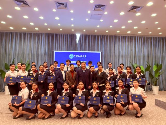 (260205) -- TIANJIN, Feb. 5, 2026 (Xinhua) -- Flight attendant trainees from Thailand with graduation certificates in hands pose for a group photo during a ceremony at the Civil Aviation University of China (CAUC) in Tianjin, north China, on Feb. 3, 2026. Yanatchara Anukun, 21, is among 28 flight attendant trainees from Thailand's Suan Dusit University (SDU), who completed a three-month study of cabin safety and management, as well as psychology of cabin service at the CAUC in Tianjin. The study is part of an aviation business exchange cooperation between CAUC and SDU. Besides that, the trainees also received practical training in a cabin simulator here to handle emergency situations in real life.  
    In October 2024, Yanatchara Anukun, as a member of SDU's teacher-student exchange group, came to China and studied for a period of time, an experience that deepened her understanding of civil aviation education and training systems of China's universities. In 2025, she once again gained the chance to China for a short-term study and training in her major. "We practiced many times in the cabin simulator to learn how to deal with the situations that may occur suddenly during flight," said Yanatchara Anukun. For her, becoming a flight attendant is not only a career choice, but also a dream. (Xinhua/Sun Fanyue)