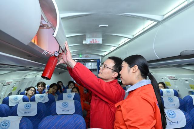 (260205) -- TIANJIN, Feb. 5, 2026 (Xinhua) -- Chinese teacher Chi Zhuang (L) teaches a flight attendant trainee from Thailand about cabin safety in a cabin simulator at the Civil Aviation University of China (CAUC) in Tianjin, north China, on Jan. 20, 2026. Yanatchara Anukun, 21, is among 28 flight attendant trainees from Thailand's Suan Dusit University (SDU), who completed a three-month study of cabin safety and management, as well as psychology of cabin service at the CAUC in Tianjin. The study is part of an aviation business exchange cooperation between CAUC and SDU. Besides that, the trainees also received practical training in a cabin simulator here to handle emergency situations in real life.  
    In October 2024, Yanatchara Anukun, as a member of SDU's teacher-student exchange group, came to China and studied for a period of time, an experience that deepened her understanding of civil aviation education and training systems of China's universities. In 2025, she once again gained the chance to China for a short-term study and training in her major. "We practiced many times in the cabin simulator to learn how to deal with the situations that may occur suddenly during flight," said Yanatchara Anukun. For her, becoming a flight attendant is not only a career choice, but also a dream. (Xinhua/Sun Fanyue)