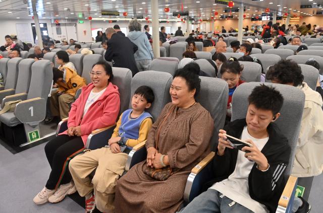 (260205) -- BEIHAI, Feb. 5, 2026 (Xinhua) -- Passengers wait for the start of the maiden voyage of the Beiyou 36 passenger ship at Beihai international port in Beihai, south China's Guangxi Zhuang Autonomous Region, Feb. 5, 2026. Beiyou 36, the 1,200-seat high-speed passenger ship newly put into operation in Baihai for the Spring Festival travel rush, has a total length of 71 meters, a designed speed of 29 knots, and a maximum speed of over 32 knots. (Xinhua/Lu Boan)