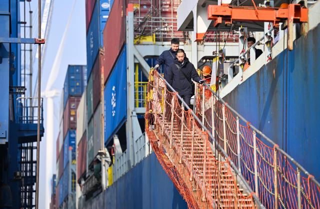 (260205) -- TIANJIN, Feb. 5, 2026 (Xinhua) -- Sun Bo (back) and Xu Qinping leave a ship to return to the dock after conducting their piloting work at Tianjin Port in Tianjin, north China, Feb. 4, 2026.
  Sun Bo and Xu Qinping are both port pilots at Tianjin Port. A port pilot needs to be familiar not only with the port's navigation conditions, but also with vessel maneuvering skills. Working around the clock across navigation channels, berthing locations and anchorage grounds, they are responsible for the safe arrival and departure of ships at the port. 
  "When guiding the anchoring of a vessel weighing hundreds of thousands of tons, we must maneuver with centimeter-level precision," said Sun Bo. According to him, the most dangerous part is embarking from the anchorage, when a pilot must choose the right moment to climb up a soft ladder. A single moment of carelessness could lead to a fall into the sea. Moreover, port pilots work year-round without breaks, with the daily ship schedule dictating their routine. 
  Over his 22-year career, Sun Bo has piloted more than 4,500 vessels and also witnessed the rapid development of China's ports and foreign trade. (Xinhua/Zhao Zishuo)