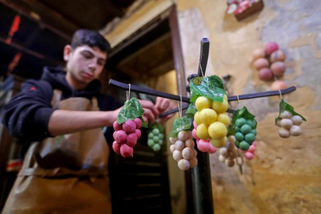 (260205) -- TRIPOLI, Feb. 5, 2026 (Xinhua) -- A man hangs bunches of grapes crafted from soap at the Soap Museum in Tripoli, northern Lebanon, Feb. 5, 2026. (Photo by Bilal Jawich/Xinhua)
