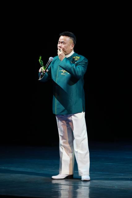 (260205) -- BISHKEK, Feb. 5, 2026 (Xinhua) -- An artist plays a song by blowing leaves at the "Happy Chinese New Year in Bishkek 2026" cultural show in Bishkek, Kyrgyzstan, Feb. 4, 2026. The show was presented by a joint artistic group composed of Fujian Vocational College of Art,  Fujian Acrobatic Troupe, Fujian song and dance theater, and Quanzhou Gaojia Opera Heritage Center. The program included songs, dances, magic, acrobatics, local opera, and instrumental performances. Nearly 900 people watched the show at the scene. (Photo by Roman/Xinhua)