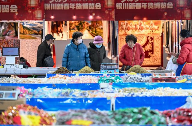 (260205) -- BEIJING, Feb. 5, 2026 (Xinhua) -- People shop at a fair featuring Chinese New Year goods in Yinchuan City, northwest China's Ningxia Hui Autonomous Region, Feb. 5, 2026. Fairs and events are held across the country, where people shop for goods in preparation for the upcoming Spring Festival, or the Chinese New Year. (Xinhua/Feng Kaihua)