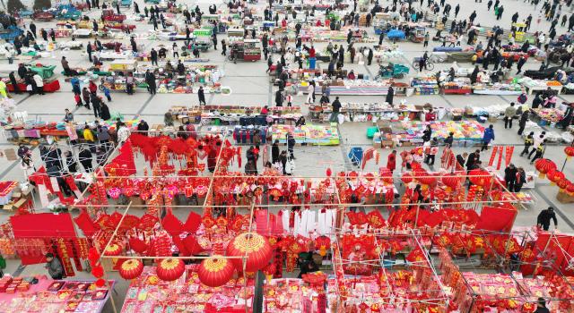 (260205) -- BEIJING, Feb. 5, 2026 (Xinhua) -- A drone photo taken on Feb. 4, 2026 shows people shopping at a fair featuring Chinese New Year goods in Liujiaxia Town of Yongjing County in Linxia Hui Autonomous Prefecture, northwest China's Gansu Province. Fairs and events are held across the country, where people shop for goods in preparation for the upcoming Spring Festival, or the Chinese New Year. (Photo by Shi Youdong/Xinhua)