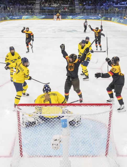 (260205) -- MILAN, Feb. 5, 2026 (Xinhua) -- Players of Germany celebrate a goal during the ice hockey women's preliminary round group B match between Sweden and Germany of the 2026 Milan-Cortina Winter Olympics in Milan, Italy, Feb. 5, 2026. (Xinhua/Sun Fei)