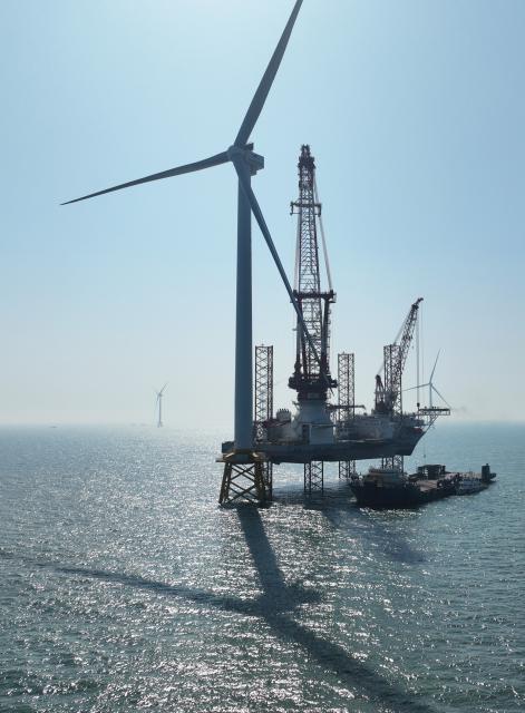 (260206) -- FUZHOU, Feb. 6, 2026 (Xinhua) -- A drone photo taken on Jan. 13, 2026 shows part of an offshore wind turbine unit and a 2,000-ton self-elevating offshore wind power installation platform on the waters of southern Fujian in southwest China. A 20-megawatt offshore wind turbine unit was put into operation on the waters of southern Fujian on Thursday, and was successfully connected to the grid for power generation. (Xinhua/Lin Shanchuan)
