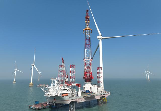 (260206) -- FUZHOU, Feb. 6, 2026 (Xinhua) -- A drone photo taken on Jan. 13, 2026 shows part of an offshore wind turbine unit and a 2,000-ton self-elevating offshore wind power installation platform on the waters of southern Fujian in southwest China. A 20-megawatt offshore wind turbine unit was put into operation on the waters of southern Fujian on Thursday, and was successfully connected to the grid for power generation. (Xinhua/Lin Shanchuan)
