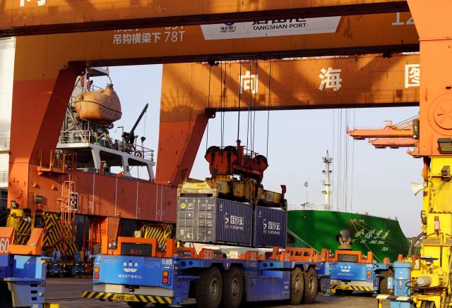 (260206) -- TANGSHAN, Feb. 6, 2026 (Xinhua) -- This photo taken on Feb. 5, 2026 shows unmanned vehicles working at a container dock of Tangshan Port in Tangshan, north China's Hebei Province. The foreign trade cargo throughput in Tangshan Port reached 381.56 million tonnes in 2025, up 2.59 percent year on year. (Xinhua/Yang Shiyao)