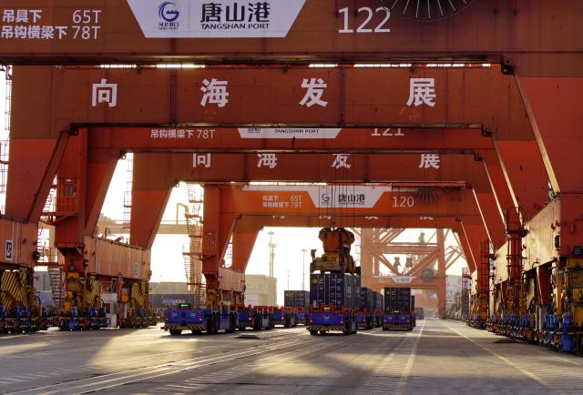 (260206) -- TANGSHAN, Feb. 6, 2026 (Xinhua) -- This photo taken on Feb. 5, 2026 shows unmanned vehicles working at a container dock of Tangshan Port in Tangshan, north China's Hebei Province. The foreign trade cargo throughput in Tangshan Port reached 381.56 million tonnes in 2025, up 2.59 percent year on year. (Xinhua/Yang Shiyao)