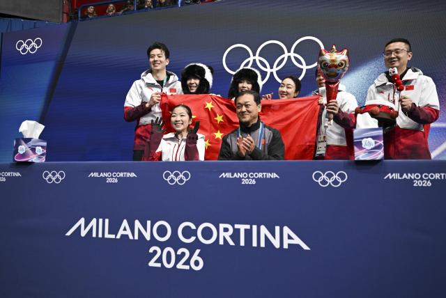 (260206) -- MILAN, Feb. 6, 2026 (Xinhua) -- Zhang Ruiyang (front L) of China waits for scores after performing during the women single skating short program of the figure skating team event of the Milan-Cortina 2026 Olympic Winter Games in Milan, Italy, Feb. 6, 2026. (Xinhua/Cheng Min)