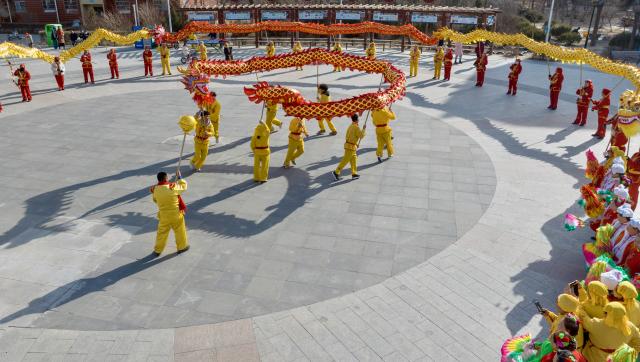 (260206) -- YINCHUAN, Feb. 6, 2026 (Xinhua) -- An aerial drone photo shows international students of North Minzu University experiencing dragon dance with local residents in Yinchuan, northwest China's Ningxia Hui Autonomous Region, Feb. 5, 2026. As the Spring Festival approaches, international students from North Minzu University were invited to a community in Yinchuan to experience traditional Chinese folk customs and share the festive joy of the Chinese New Year with local residents. (Xinhua/Yang Zhisen)
