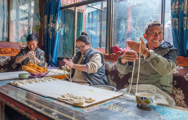 (260206) -- SHANNAN, Feb. 6, 2026 (Xinhua) -- Villagers make traditional snacks for the upcoming Tibetan New Year at home in Yumai Town of Lhunze County in Shannan City, southwest China's Xizang Autonomous Region, Feb. 5, 2026. Yumai Town, located on the southern foot of the Himalayas, was once home to merely three permanent residents due to its harsh and rugged terrain. Today, residential houses here are neatly arranged, with comprehensive infrastructure including drainage and communication facilities in place. 
   Schools, health clinics, and hotels have also been established, alongside with home-stays, small shops, and courier stations operated by villagers.
   In 2025, the area received over 12,000 tourists, with home-stay income exceeding 284,200 yuan. (Xinhua/Tenzin Nyida)