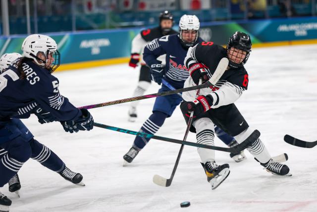 (260206) -- MILAN, Feb. 6, 2026 (Xinhua) -- Sato Kohane (R) of Japan competes during the Women's Preliminary Round Group B match between France and Japan of Ice Hockey of the 2026 Milan-Cortina Olympic Winter Games in Milan, Italy, Feb. 6, 2026. (Zhang Cheng/Pool via Xinhua)