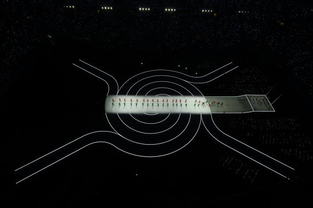 (260206) -- MILAN, Feb. 6, 2026 (Xinhua) -- Three groups of models walk the runway wearing creations designed by Giorgio Armani during the opening ceremony of the Milan-Cortina 2026 Olympic Winter Games at the San Siro Olympic Stadium in Milan, Italy, Feb. 6, 2026. (Xinhua/Chen Yichen)