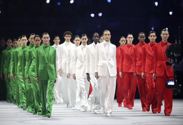 (260206) -- MILAN, Feb. 6, 2026 (Xinhua) -- Three groups of models walk the runway wearing creations designed by Giorgio Armani during the opening ceremony of the Milan-Cortina 2026 Olympic Winter Games at the San Siro Olympic Stadium in Milan, Italy, Feb. 6, 2026. (Xinhua/Li Ming)