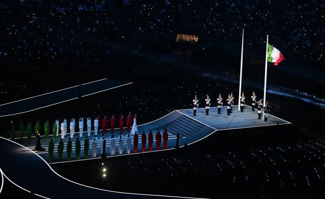 (260206) -- MILAN, Feb. 6, 2026 (Xinhua) -- The Italian national flag is raised during the opening ceremony of the Milan-Cortina 2026 Olympic Winter Games at the San Siro Olympic Stadium in Milan, Italy, Feb. 6, 2026. (Xinhua/Cheng Min)
