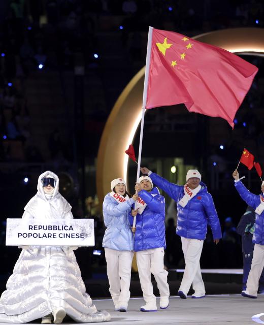 (260206) -- MILAN, Feb. 6, 2026 (Xinhua) -- Flagbearers Ning Zhongyan (3rd R) and Zhang Chutong (2nd L) of the delegation of China parade into the San Siro Olympic Stadium during the opening ceremony of the Milan-Cortina 2026 Olympic Winter Games in Milan, Italy, Feb. 6, 2026. (Xinhua/Li Ming)