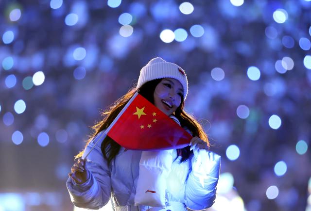 (260207) -- MILAN, Feb. 7, 2026 (Xinhua) -- A member of the delegation of China parades into the San Siro Olympic Stadium during the opening ceremony of the Milan-Cortina 2026 Olympic Winter Games in Milan, Italy, Feb. 6, 2026. (Xinhua/Li Ming)