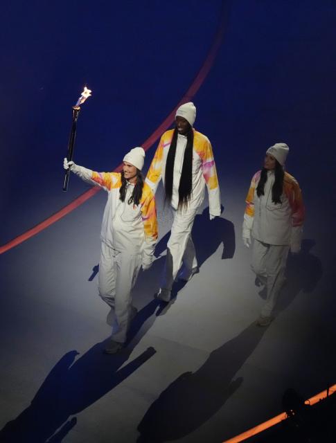 (260207) -- MILAN, Feb. 7, 2026 (Xinhua) -- Torchbearers run with the Olympic flame during the opening ceremony of the Milan-Cortina 2026 Olympic Winter Games at the San Siro Olympic Stadium in Milan, Italy, Feb. 6, 2026. (Xinhua/Xue Yuge)