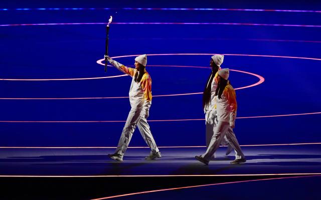 (260207) -- MILAN, Feb. 7, 2026 (Xinhua) -- Torchbearers walk with the Olympic flame during the opening ceremony of the Milan-Cortina 2026 Olympic Winter Games at the San Siro Olympic Stadium in Milan, Italy, Feb. 6, 2026. (Xinhua/Tao Xiyi)