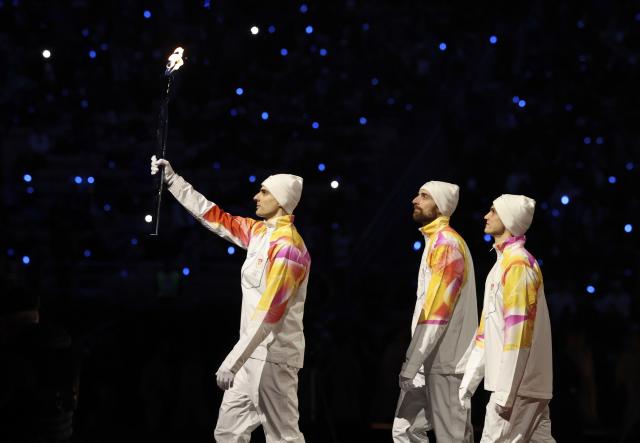 (260207) -- MILAN, Feb. 7, 2026 (Xinhua) -- Torchbearers walk with the Olympic flame during the opening ceremony of the Milan-Cortina 2026 Olympic Winter Games at the San Siro Olympic Stadium in Milan, Italy, Feb. 6, 2026. (Xinhua/Li Jing)