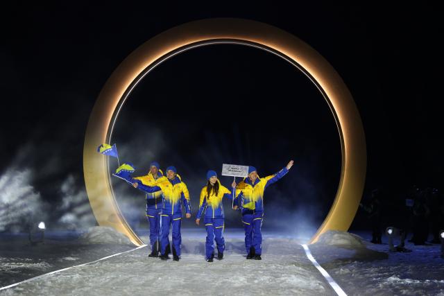 (260207) -- PREDAZZO, Feb. 7, 2026 (Xinhua) -- The delegation of Bosnia and Herzegovina parades into the Predazzo Ski Jumping Stadium during the opening ceremony of the Milan-Cortina 2026 Olympic Winter Games in Predazzo, Italy, Feb. 6, 2026. (Xinhua/Huang Wei)