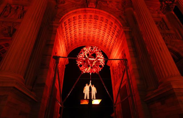 (260207) -- MILAN, Feb. 7, 2026 (Xinhua) -- Torchbearers Deborah Compagnoni (R) and Alberto Tomba ignite the cauldron of the Milan-Cortina 2026 Olympic Winter Games at the Arco della Pace in Milan, Italy, Feb. 6, 2026. (Jamie Squire/Pool via Xinhua)