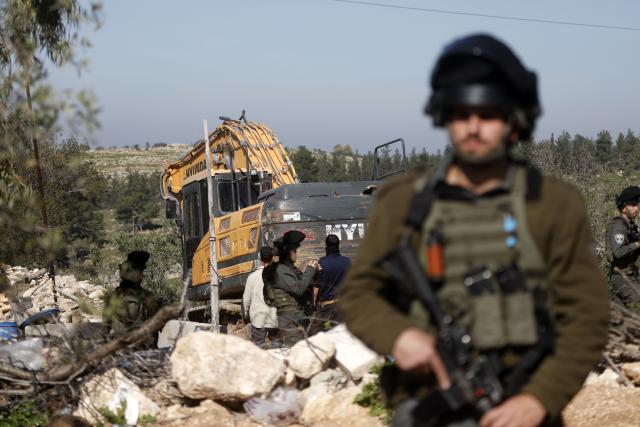 (260207) -- HEBRON, Feb. 7, 2026 (Xinhua) -- Israeli soldiers are seen as an Israeli military excavator demolishes a Palestinian home in the town of Beit Awa, west of Hebron in the West Bank, on Feb. 5, 2026. (Photo by Mamoun Wazwaz/Xinhua)
