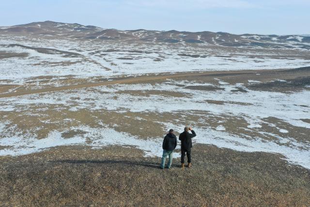 (260207) -- CHANGJI, Feb. 7, 2026 (Xinhua) -- A drone photo taken on Feb. 4, 2026 shows staff members of a Przewalski's horse monitoring station searching for Przewalski's horses at the Karamaile Mountain Nature Reserve, northwest China's Xinjiang Uygur Autonomous Region. The Przewalski's horse, a globally endangered species under first-class national protection in China, was once extinct in the wild within the country. In 1985, China launched a reintroduction program, bringing the horses back from abroad for breeding. After more than 40 years of scientific protection and breeding, the population of Przewalski's horses in China has surpassed 900, accounting for one-third of the global total.
  At the Karamaile Mountain Nature Reserve, conservation workers work year-round as guardians of the Przewalski's horses. As the Spring Festival approaches, they continue conducting regular monitoring of the horses, identifying potential risks in the wild, and ensuring the horses can safely make it through the winter. (Xinhua/Ding Lei)
