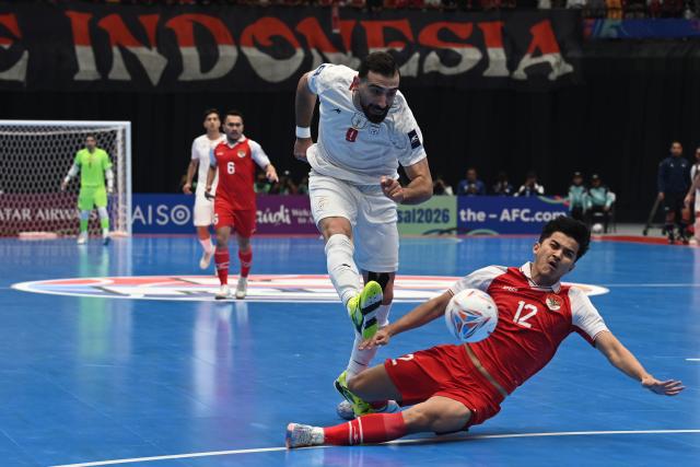 (260207) -- JAKARTA, Feb. 7, 2026 (Xinhua) -- Saied Ahmad Abbasi (L) of Iran vies with Dewa Rizki Amanda of Indonesia during the final match between Indonesia and Iran at the AFC Futsal Asian Cup 2026 in The Indonesia Arena stadium, Jakarta, Indonesia, Feb. 7, 2026. (Xinhua/Agung Kuncahya B.)
