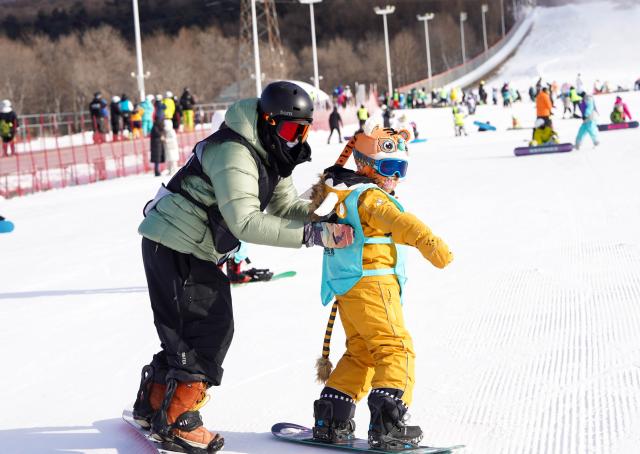 (260207) -- BEIJING, Feb. 7, 2026 (Xinhua) -- A student experiences snowboarding at a ski resort in Jilin City, northeast China's Jilin Province, Dec. 3, 2025. (Xinhua/Yan Linyun)
