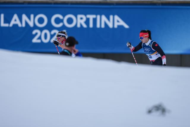 (260207) -- TESERO, Feb. 7, 2026 (Xinhua) -- Dinigeer Yilamujiang (R) of China competes during the Cross-Country Skiing Women's 10km+10km Skiathlon of the Milan-Cortina 2026 Olympic Winter Games in Tesero, Italy, Feb. 7, 2026. (Xinhua/Peng Ziyang)