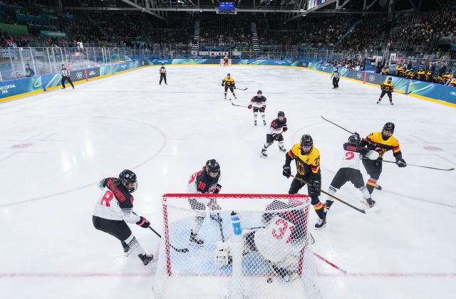 (260207) -- MILAN, Feb. 7, 2026 (Xinhua) -- Laura Kluge (3rd R, front) of Germany shoots to score during the ice hockey women's preliminary round group B match between Germany and Japan of the Milan-Cortina 2026 Olympic Winter Games in Milan, Italy, Feb. 7, 2026. (Xinhua/Sun Fei)