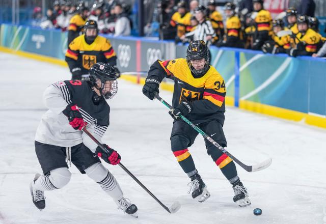 (260207) -- MILAN, Feb. 7, 2026 (Xinhua) -- Celina Haider (R) of Germany vies with Shiga Aoi of Japan during the ice hockey women's preliminary round group B match between Germany and Japan of the Milan-Cortina 2026 Olympic Winter Games in Milan, Italy, Feb. 7, 2026. (Xinhua/Sun Fei)