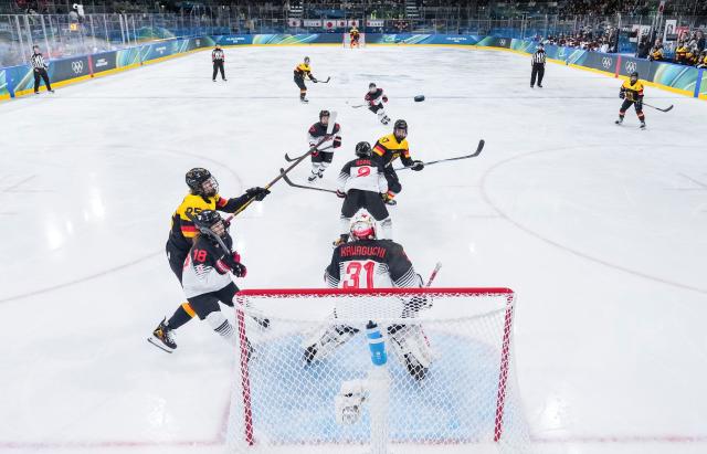 (260207) -- MILAN, Feb. 7, 2026 (Xinhua) -- Laura Kluge (1st L) of Germany shoots during the ice hockey women's preliminary round group B match between Germany and Japan of the Milan-Cortina 2026 Olympic Winter Games in Milan, Italy, Feb. 7, 2026. (Xinhua/Sun Fei)