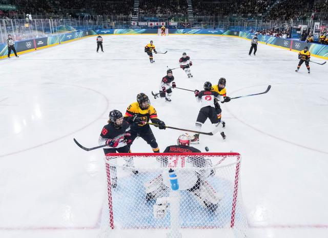 (260207) -- MILAN, Feb. 7, 2026 (Xinhua) -- Laura Kluge (2nd L) of Germany shoots to score during the ice hockey women's preliminary round group B match between Germany and Japan of the Milan-Cortina 2026 Olympic Winter Games in Milan, Italy, Feb. 7, 2026. (Xinhua/Sun Fei)