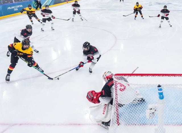 (260207) -- MILAN, Feb. 7, 2026 (Xinhua) -- Celina Haider (1st L) of Germany shoots during the ice hockey women's preliminary round group B match between Germany and Japan of the Milan-Cortina 2026 Olympic Winter Games in Milan, Italy, Feb. 7, 2026. (Xinhua/Sun Fei)