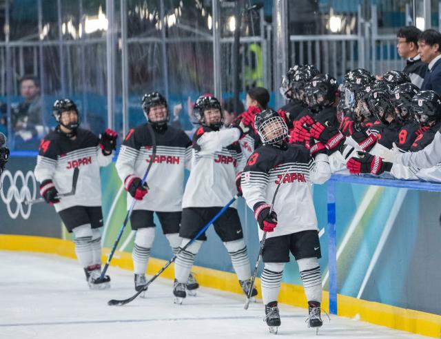 (260207) -- MILAN, Feb. 7, 2026 (Xinhua) -- Players of Japan celebrate scoring during the ice hockey women's preliminary round group B match between Germany and Japan of the Milan-Cortina 2026 Olympic Winter Games in Milan, Italy, Feb. 7, 2026. (Xinhua/Sun Fei)