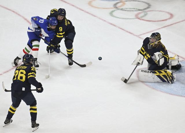 (260207) -- MILAN, Feb. 7, 2026 (Xinhua) -- Aurora Abatangelo (top, L) of Italy shoots during the ice hockey women's preliminary round group B match between Sweden and Italy at the Milan-Cortina 2026 Olympic Winter Games in Milan, Italy, Feb. 7, 2026. (Xinhua/Zhang Haofu)