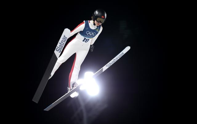 (260207) -- PREDAZZO, Feb. 7, 2026 (Xinhua) -- Dong Bing of China competes during the first round of the ski jumping women's normal hill individual at the Milan-Cortina 2026 Olympic Winter Games in Predazzo, Italy, Feb. 7, 2026. (Xinhua/Huang Wei)